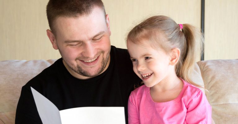 Toddler reading with father