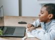 Student doing online extracurricular activities via laptop from home