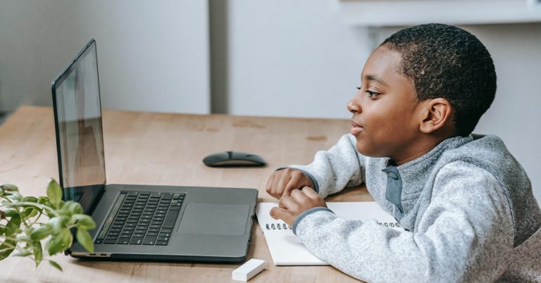 Student doing online extracurricular activities via laptop from home