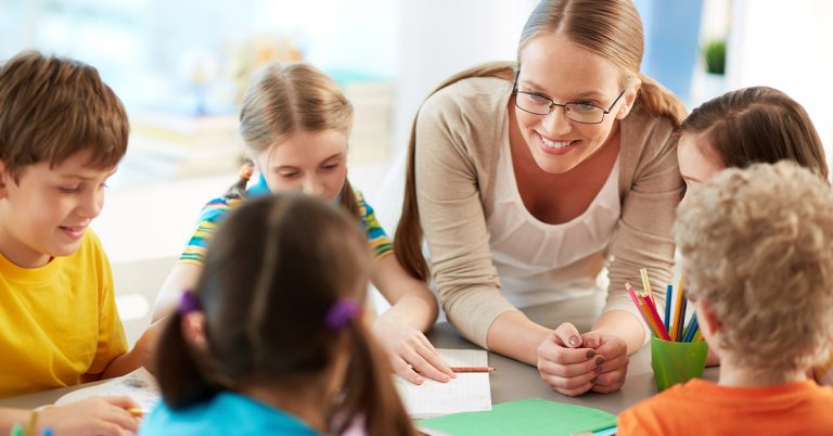 Kids are playing with their teacher