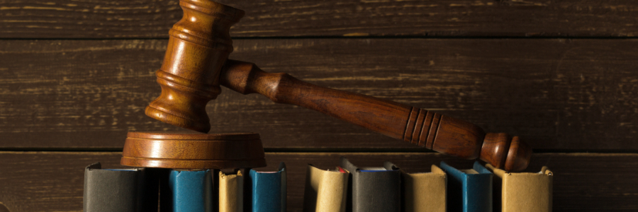 Gavel and books on wooden desk