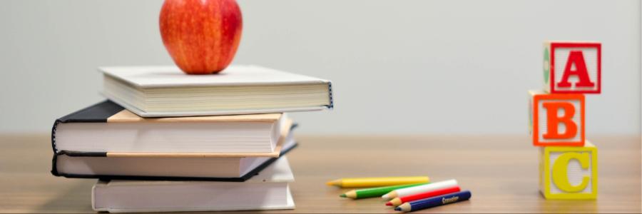 An apple and books on the table