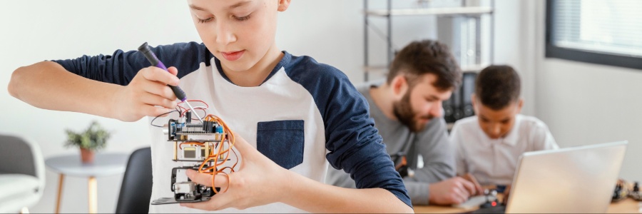 Kids building a robot with the teacher