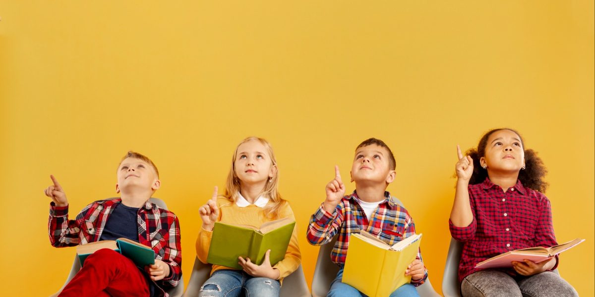 kids-with-books-sitting School kids holding books
