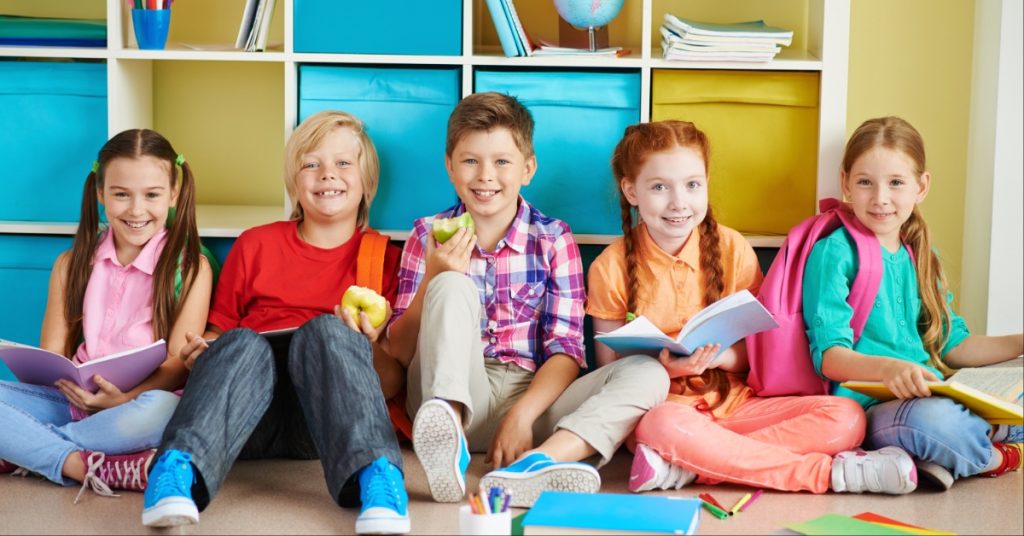 Children sitting and smiling at the camera