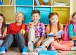 Children sitting and smiling at the camera